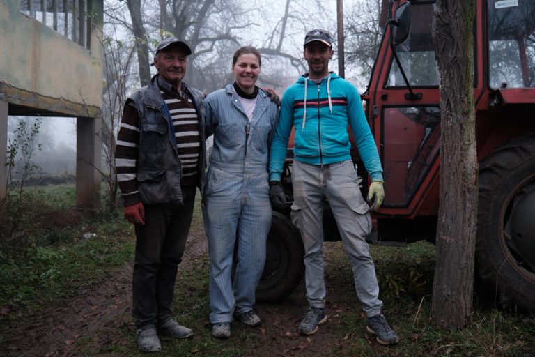 workers posing by a traktor