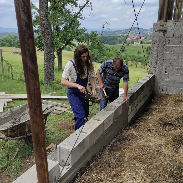 workers building concrete blocks wall