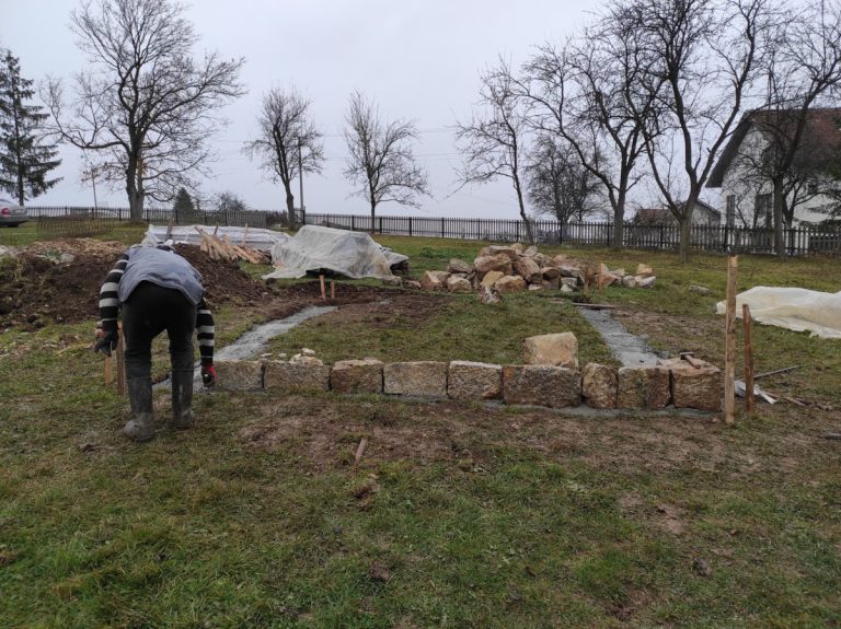 a worker building a cottage foundation