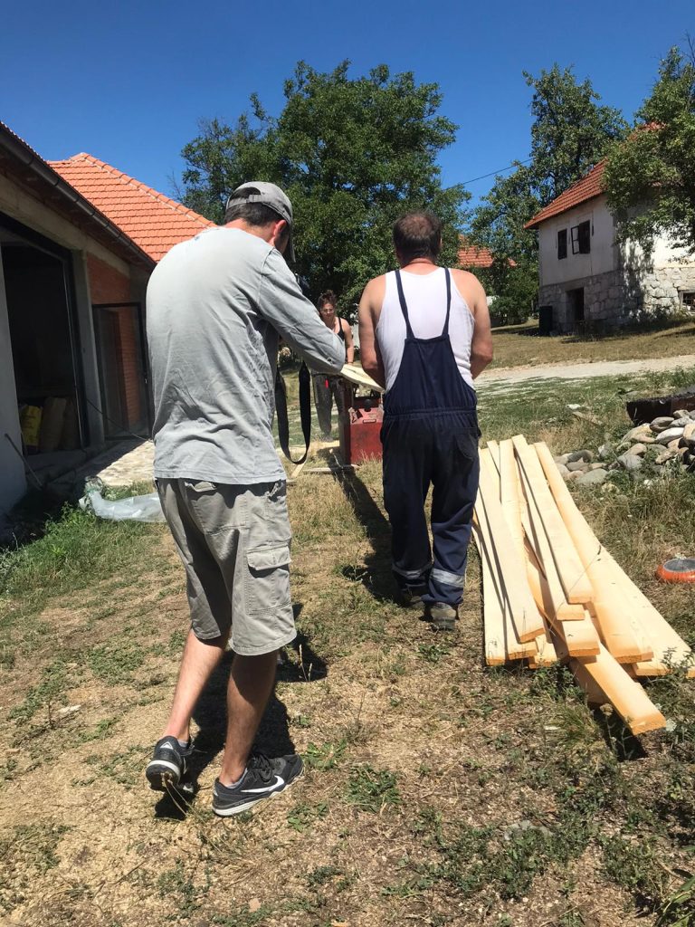 workers planing a wood beam