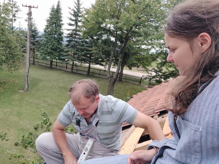 workers reconstructing a roof