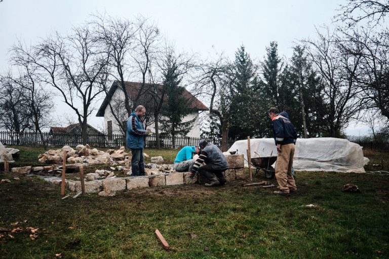 workers building a cottage foundation