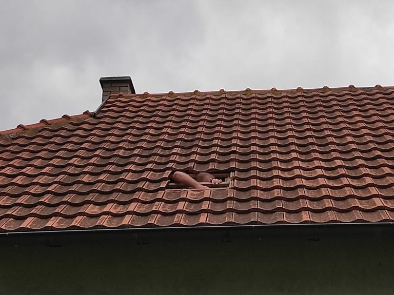 a worker reconstructing a roof