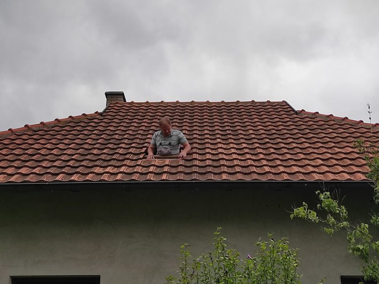 a worker on a roof of a house