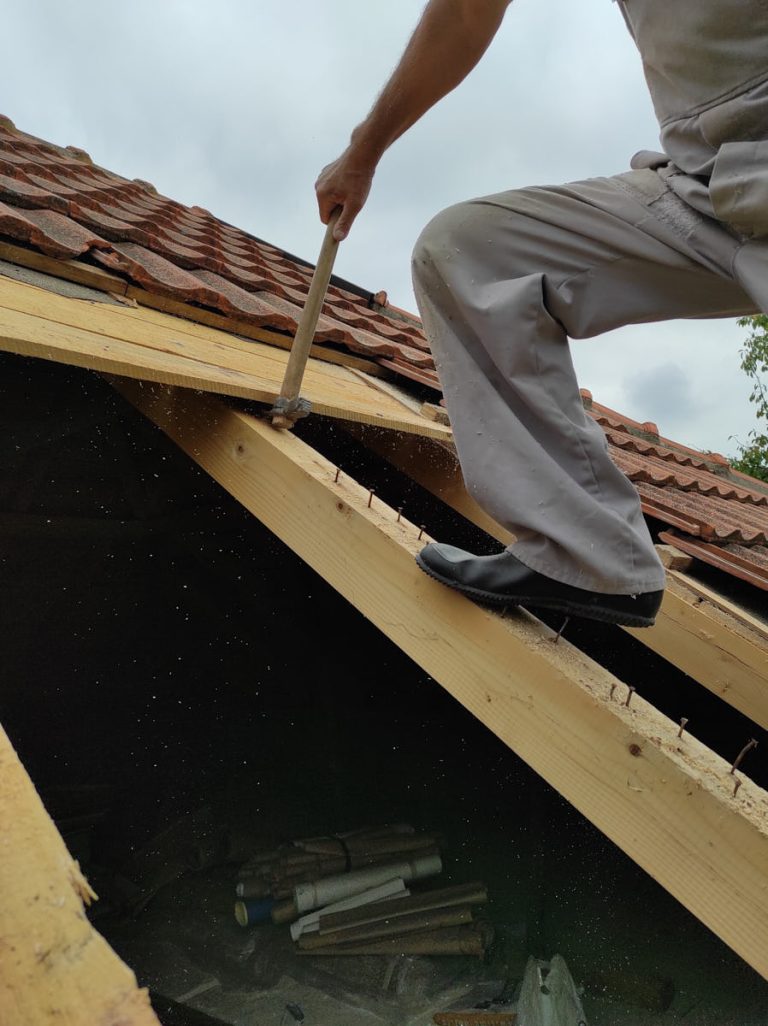 a worker restoring a roof of a house