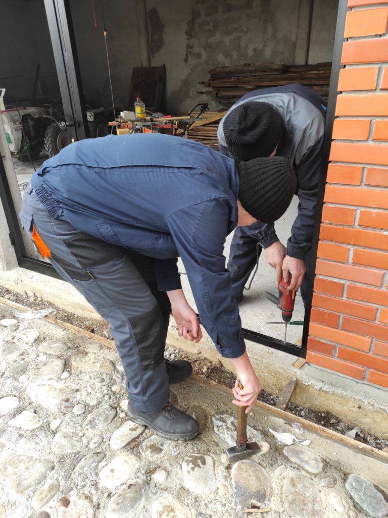 workers install glass into the door frame