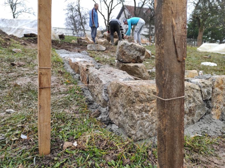 workers building a cottage foundation