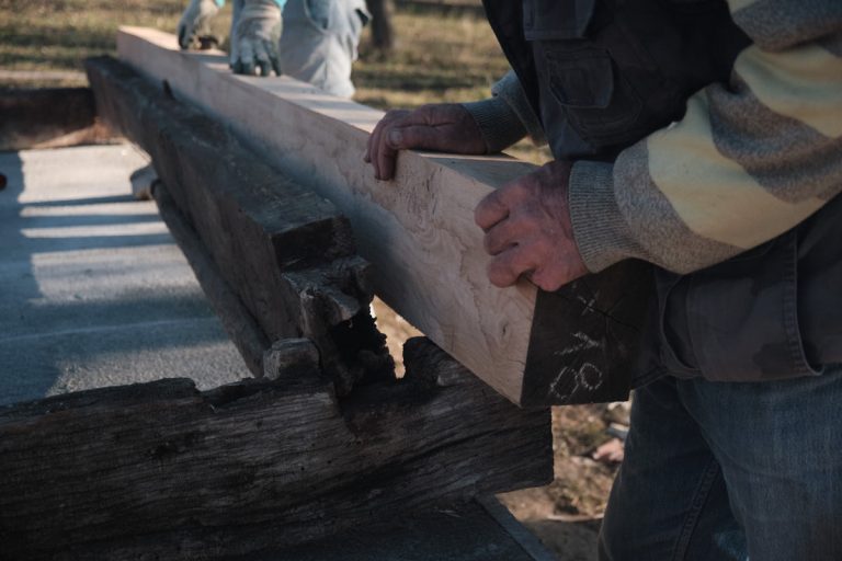 workers assembling a wooden cottage