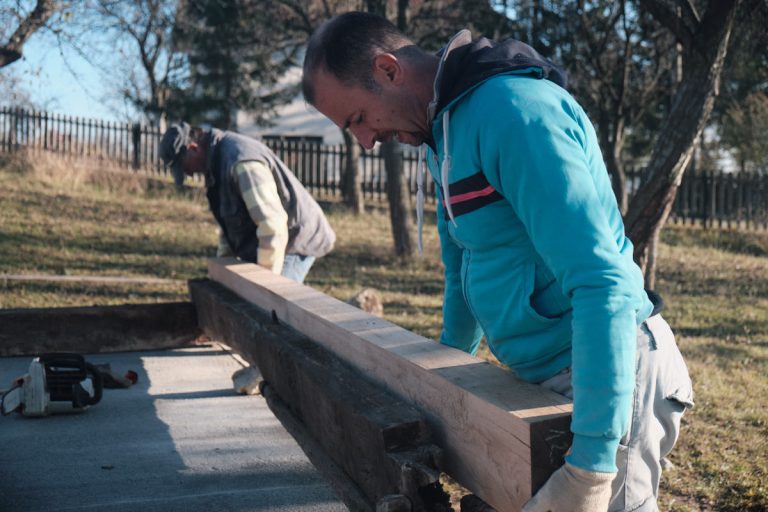 workers assembling a wooden cottage
