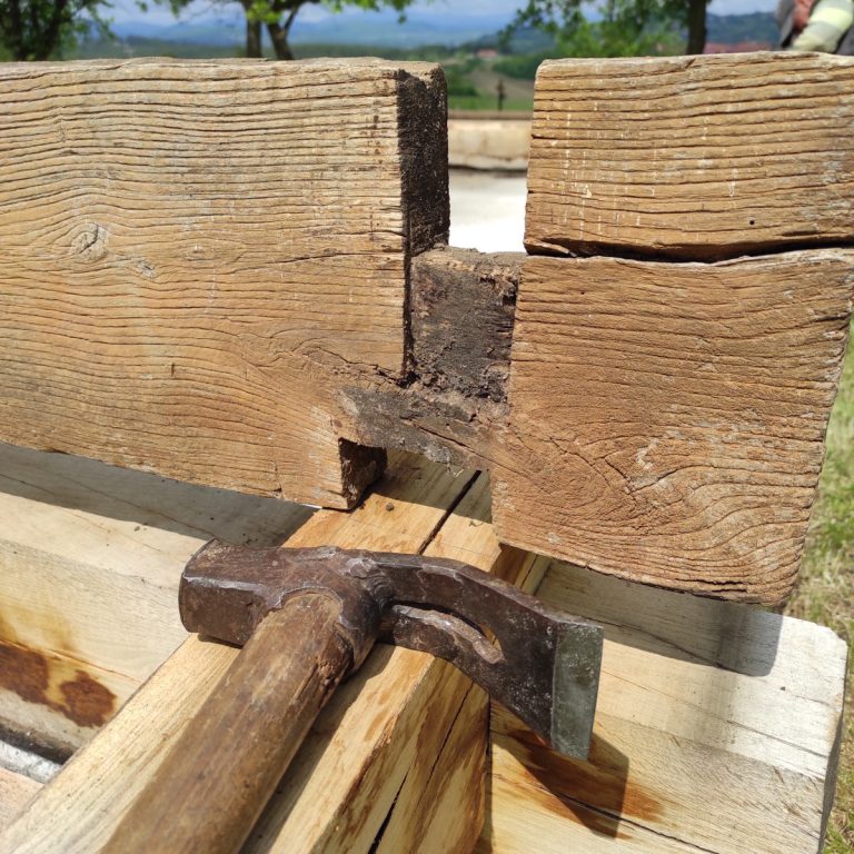 wooden beams intersection and a clawhammer