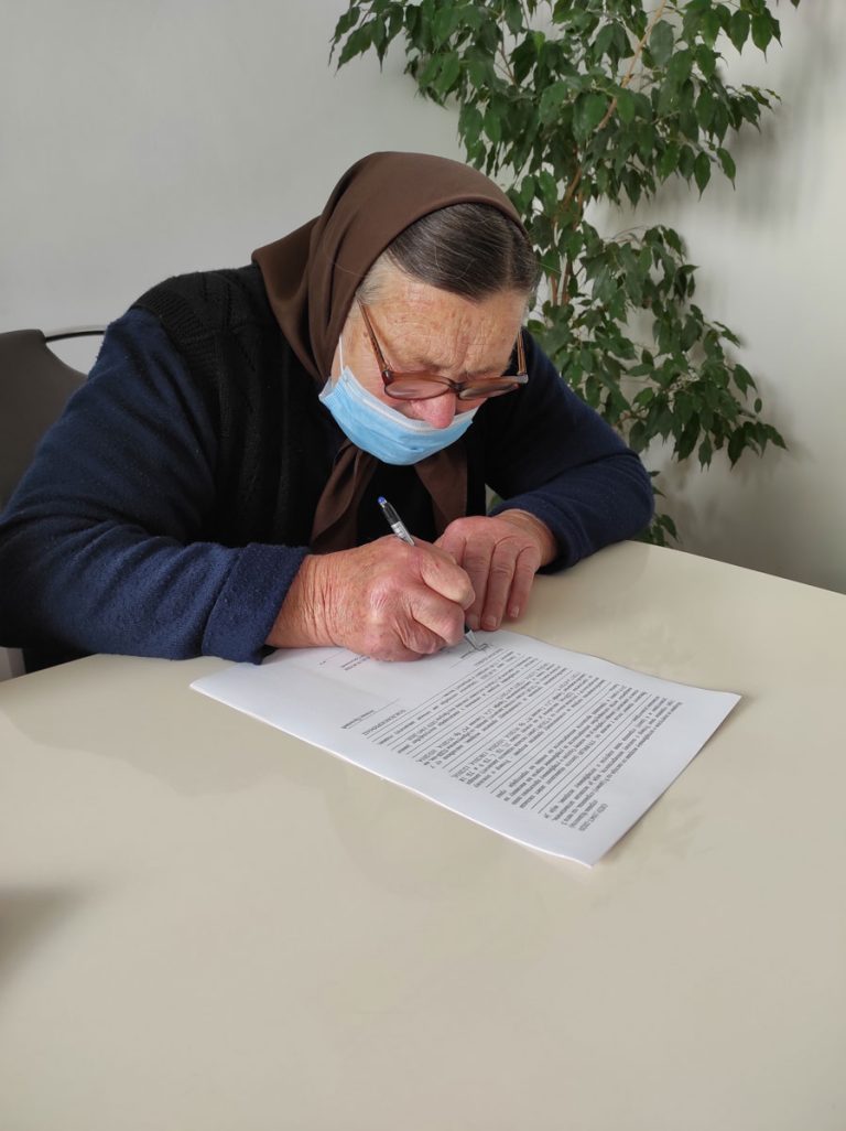 a grandmather signing a contract