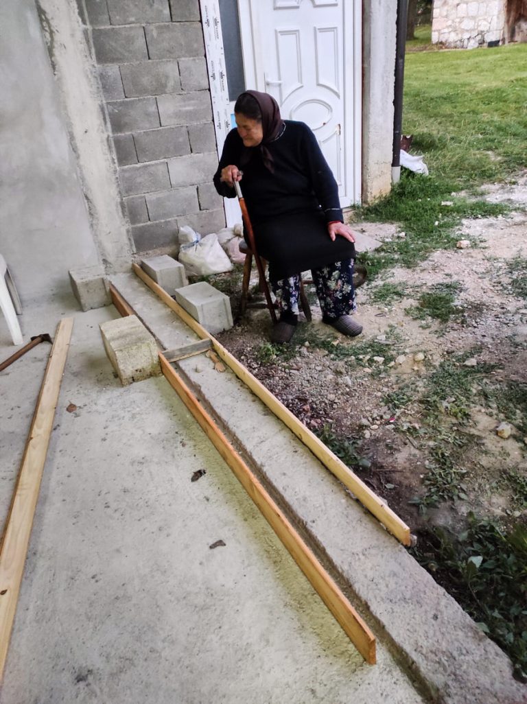 a grandmather supervising the work done by the workers