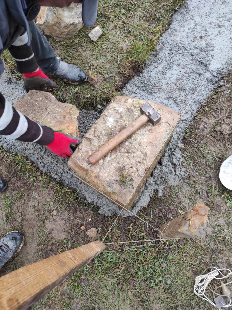 a worker building a cottage foundation