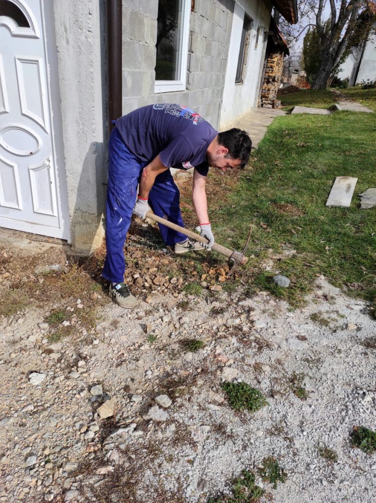 a worker digging with pickaxe