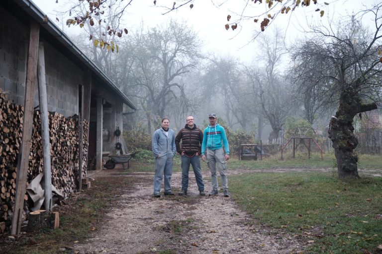 workers posing by a garage