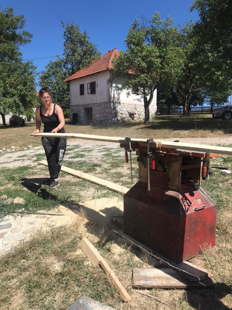workers planing a wood beam