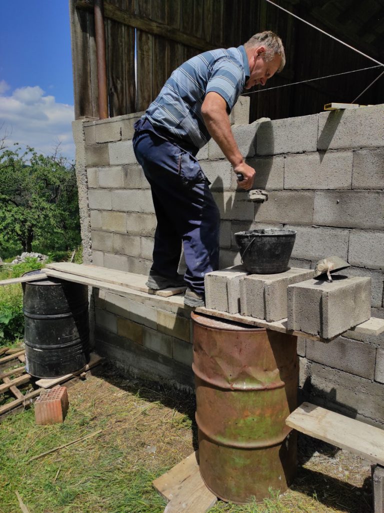 a worker building concrete blocks wall