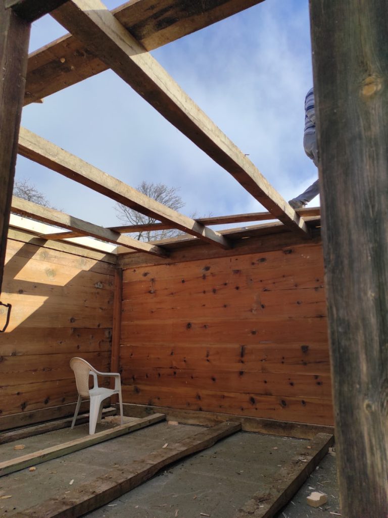 workers assembling a wooden cottage