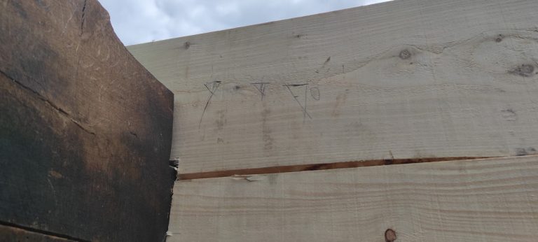 an old wooden cabin corner and marks