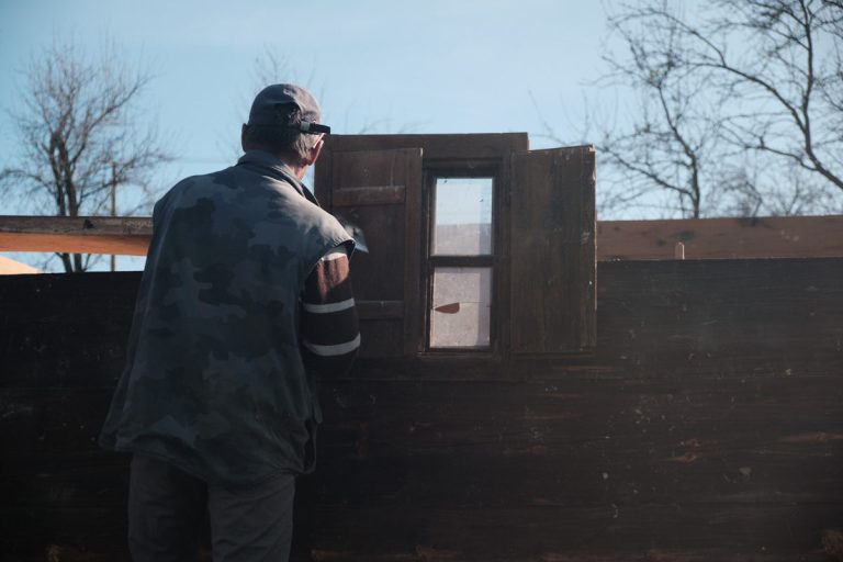 workers assembling a wooden cottage