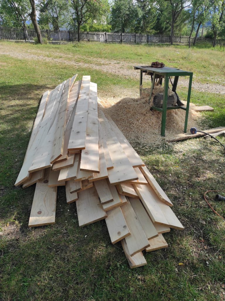 pile of wooden planks next to the table saw