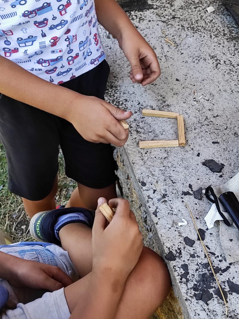 kids making objects with wooden sticks