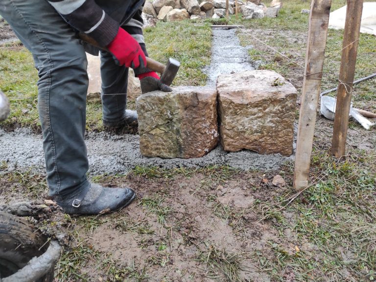 a worker building a cottage foundation