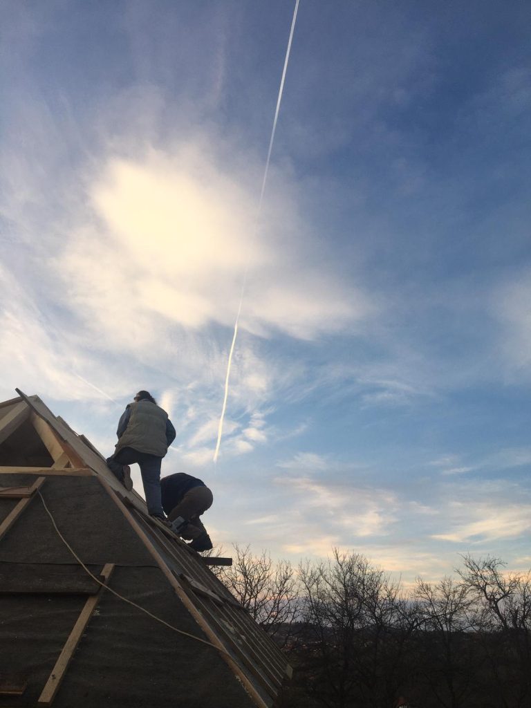 workers making new roof construction