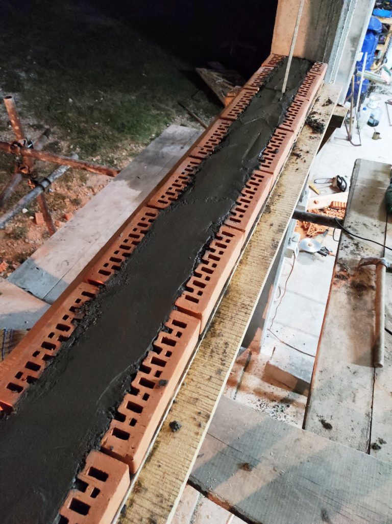 a concrete beam on a brick wall