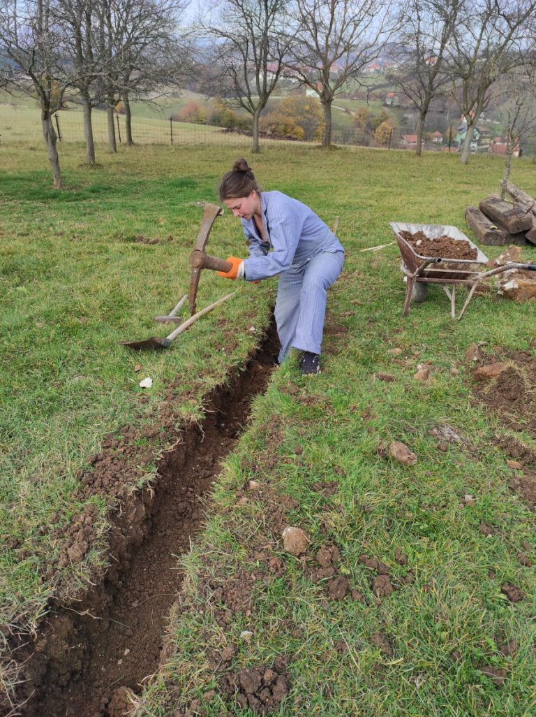 a worker digging a foudation with a pickaxe