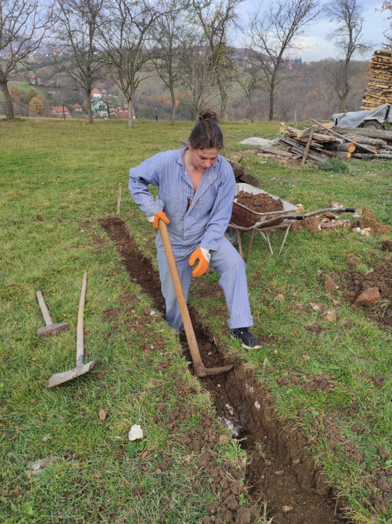 a worker digging a foudation with a pickaxe