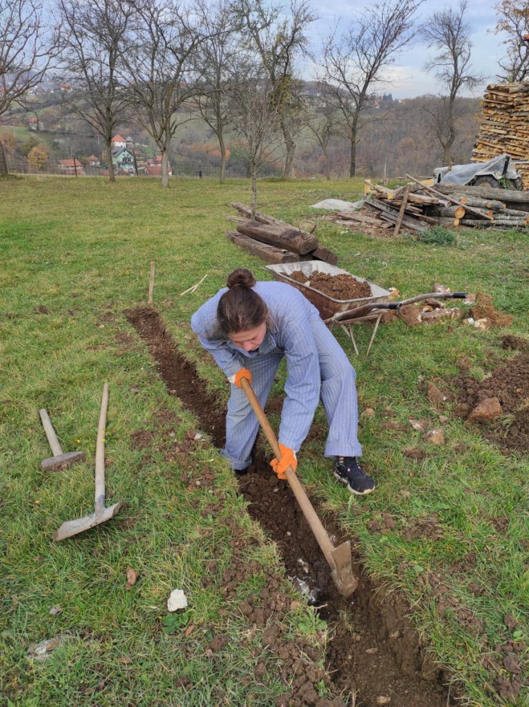 a worker digging a foudation with a pickaxe