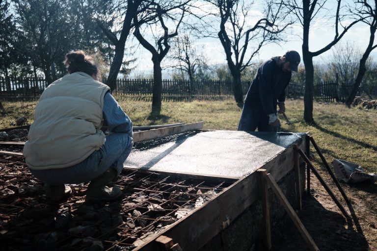 workers building concrete foundation