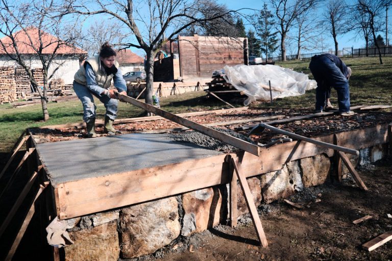workers building concrete foundation