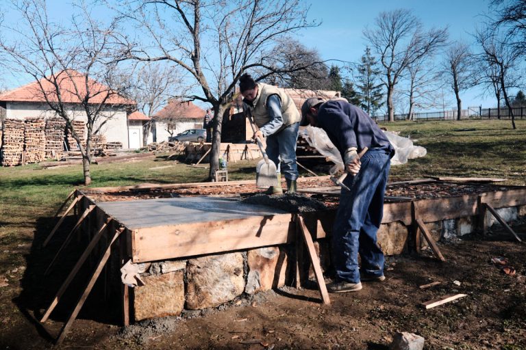 workers building concrete foundation