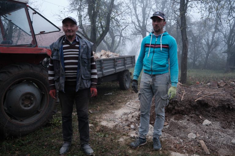 workers posing by a traktor