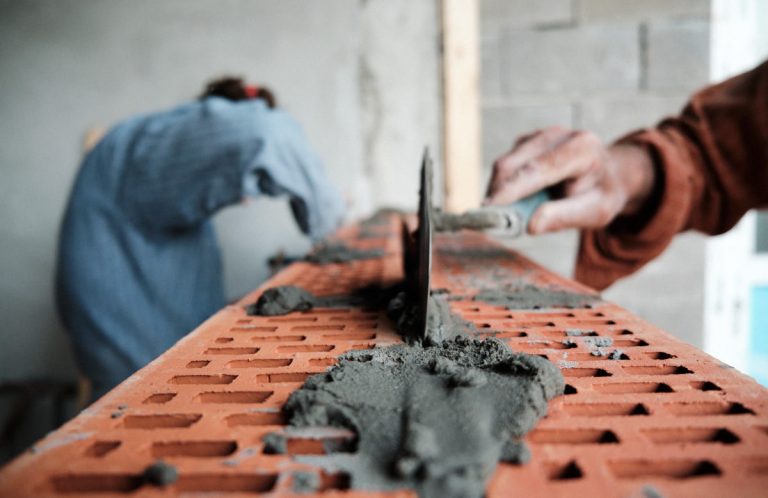 workers building a brick wall