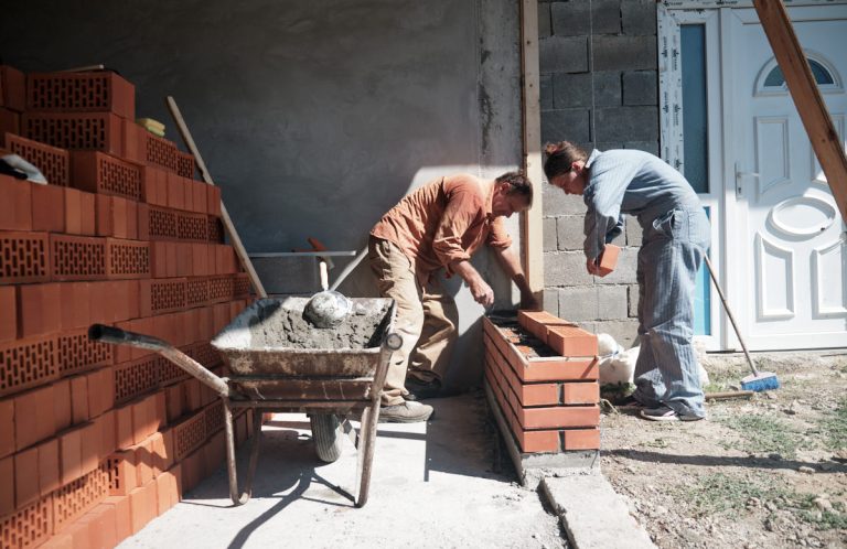 workers building a brick wall
