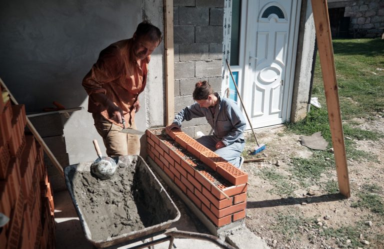 a worker building a brick wall