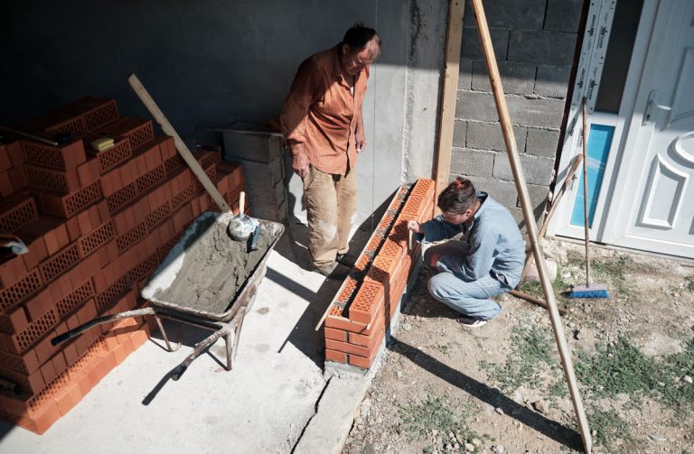 a worker building a brick wall