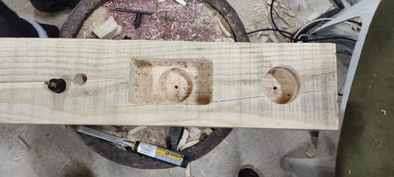 a wooden beam with holes for electric switches