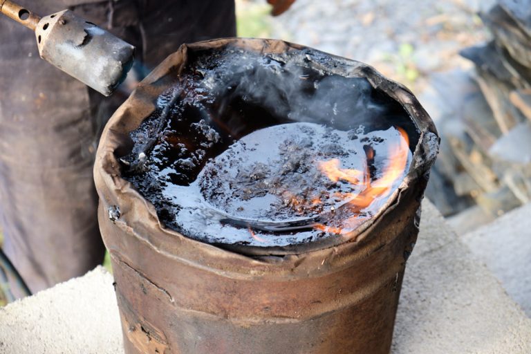 a torch melting bitumen