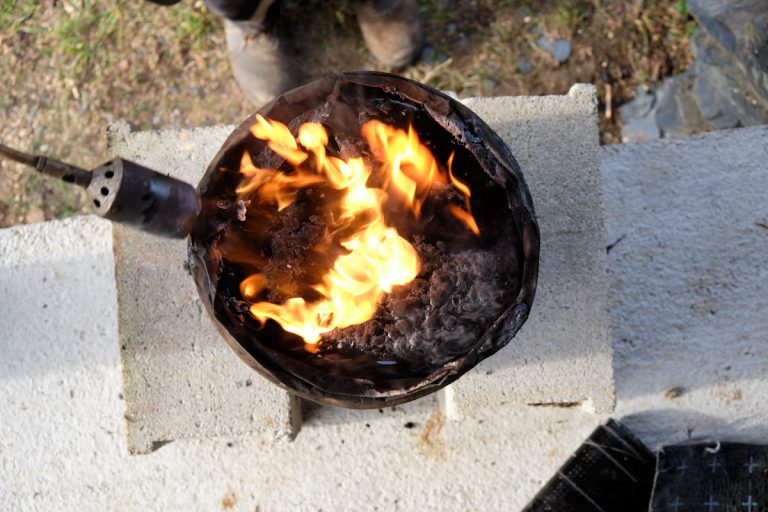 a torch melting bitumen
