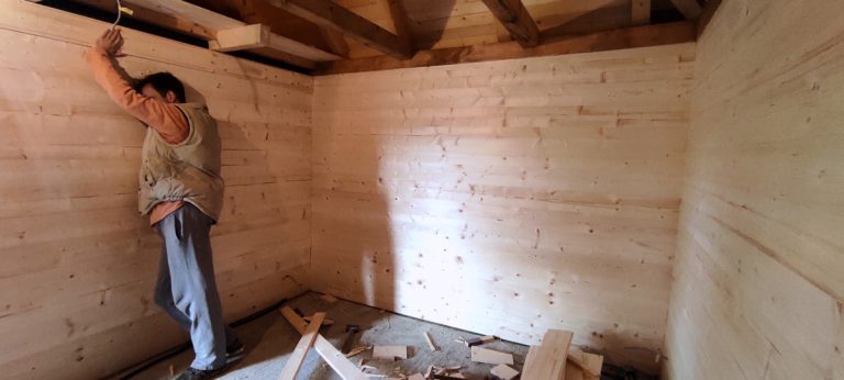 a man in a wooden cottage