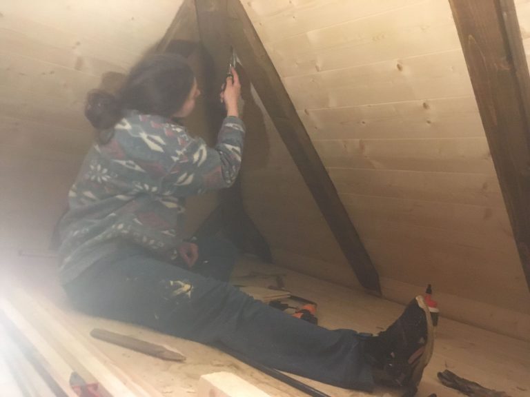 a girl cleaning wooden rafters