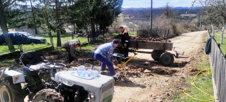 people digging a water channel