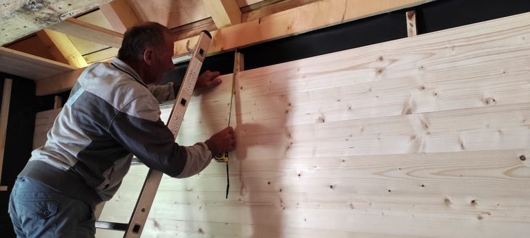 a worker measuring a distance