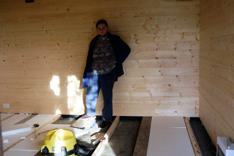 a woman in a wooden cottage