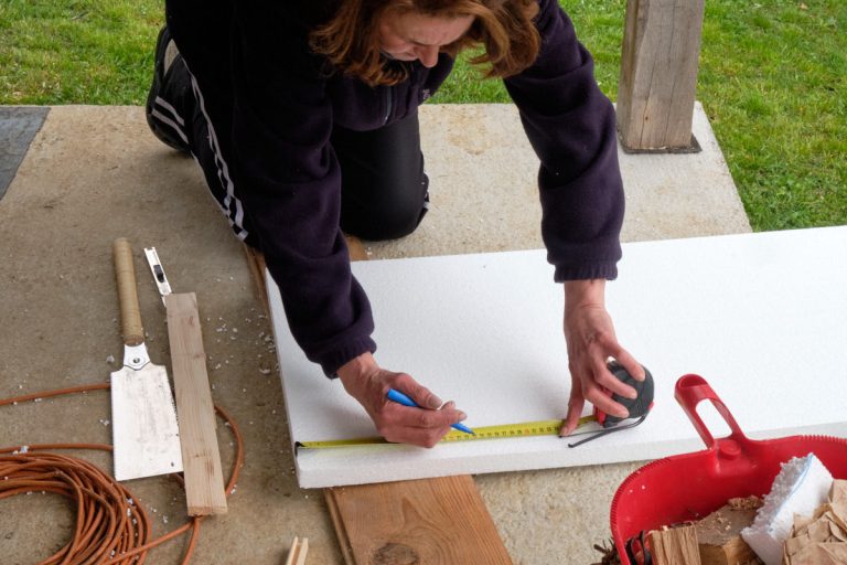 a woman marking a styrofoam board