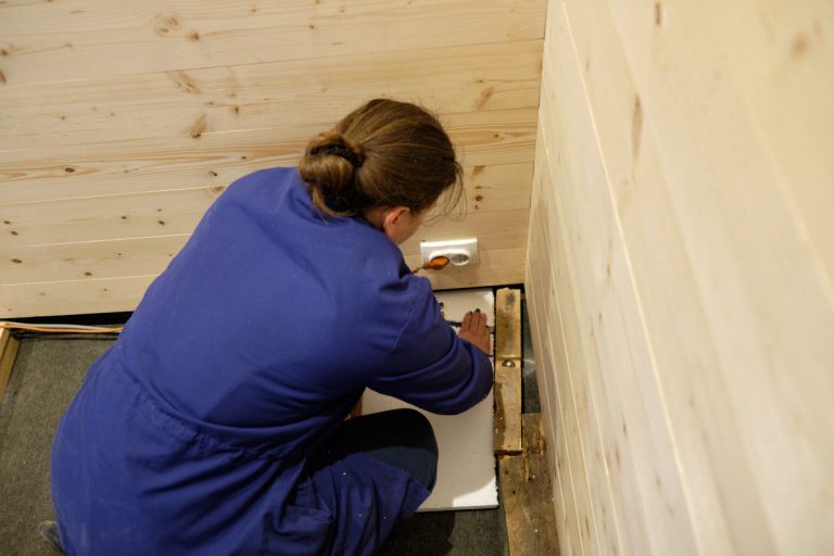 a woman measuring a styrofoam board